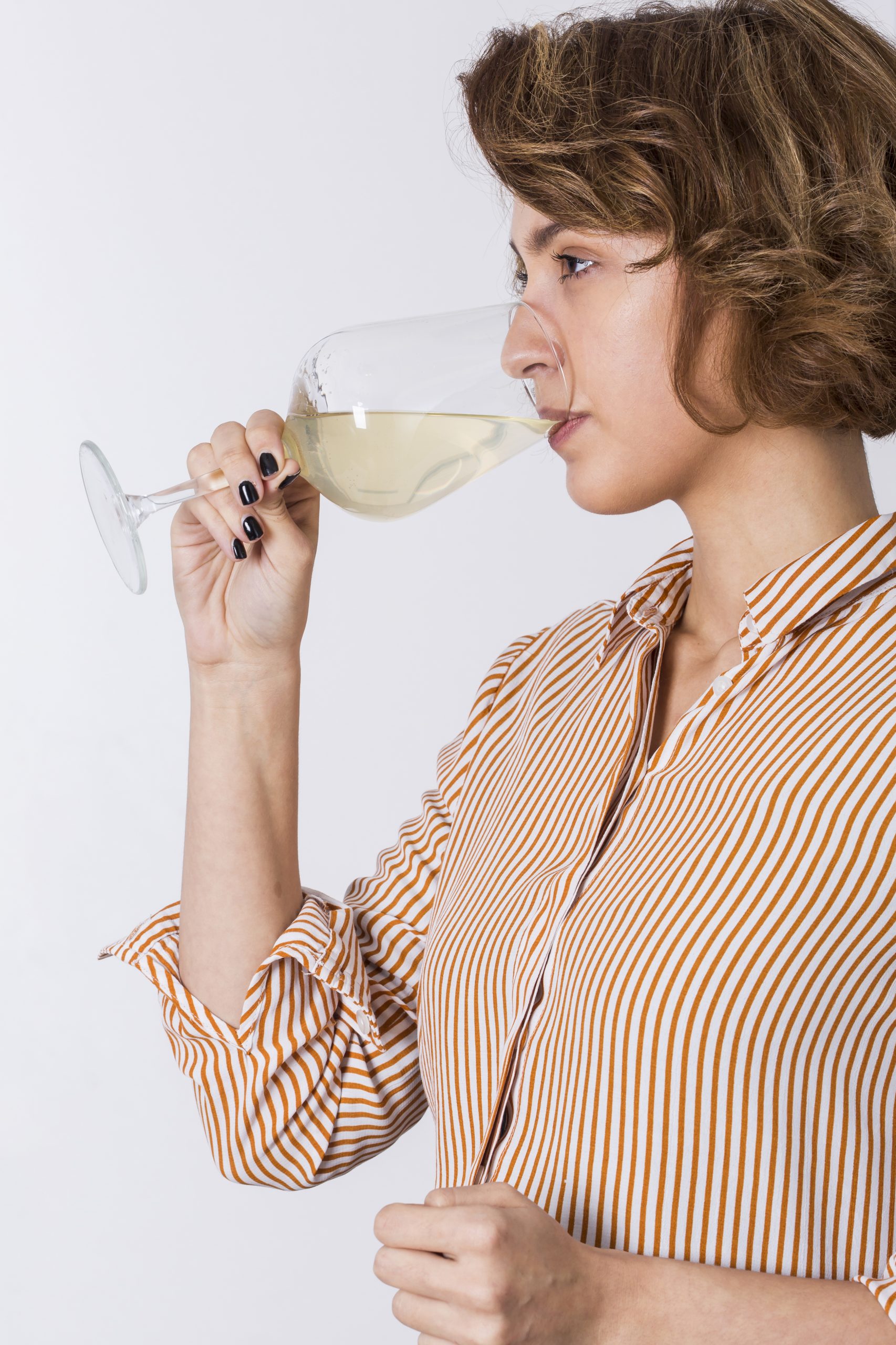 woman drinking glass of white wine